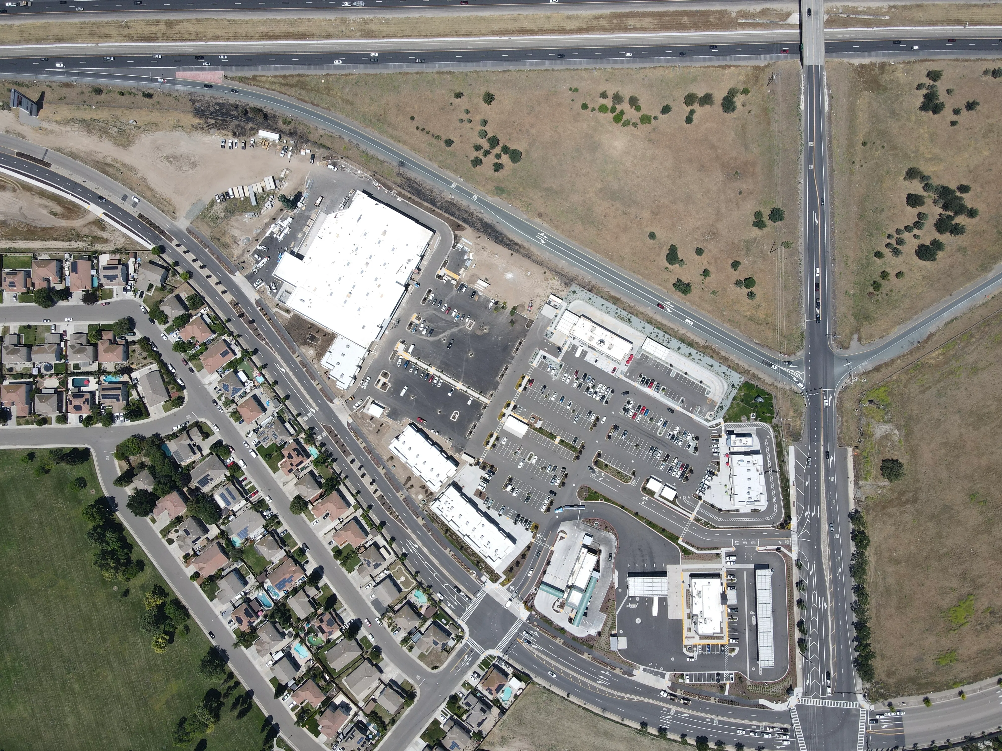 Top-down aerial view of the full Manteca Crossing site at Highway 120 and Airport Way