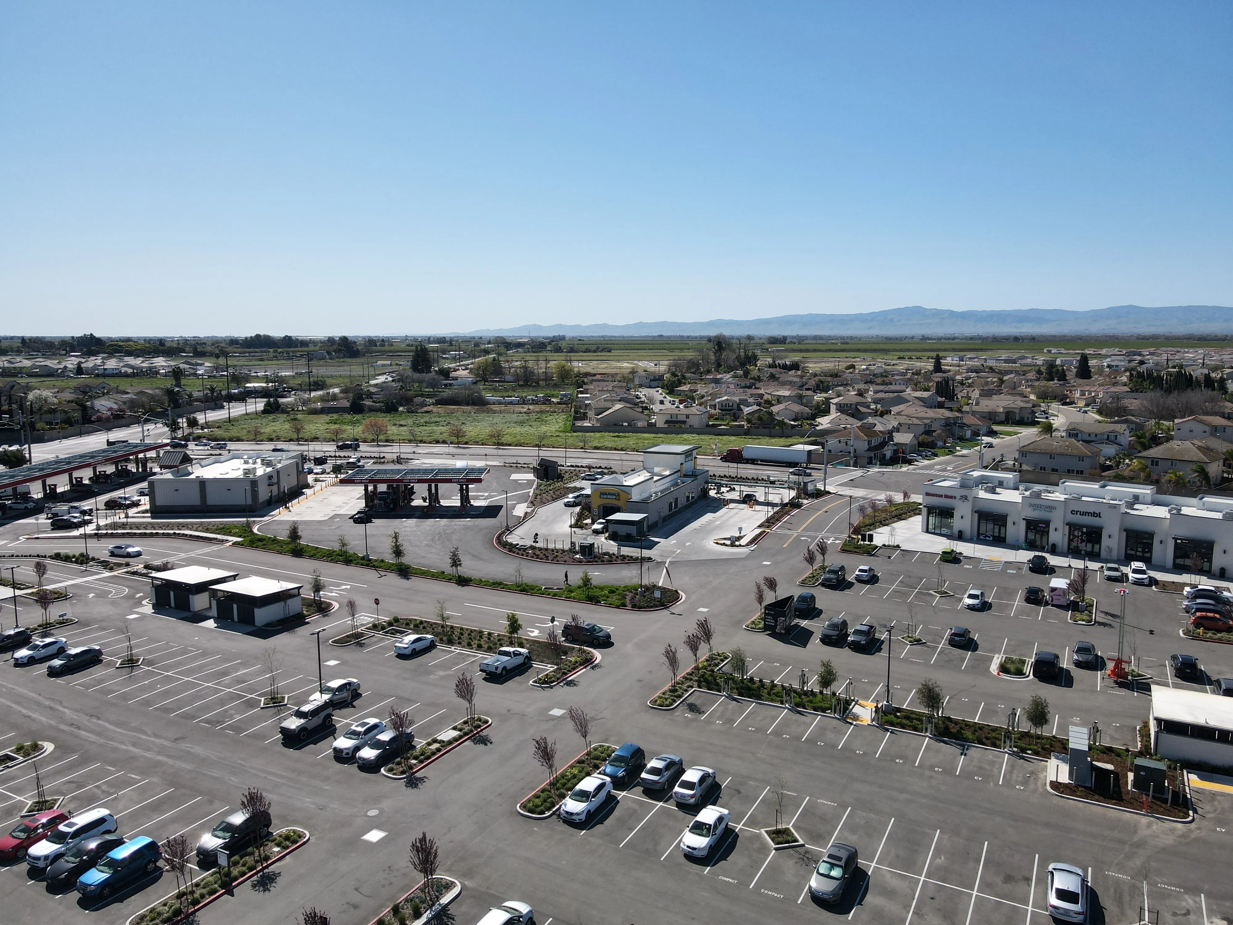 Aerial view of Manteca Crossing at Highway 120 and Airport Way, with the Sierra Nevada foothills in the background