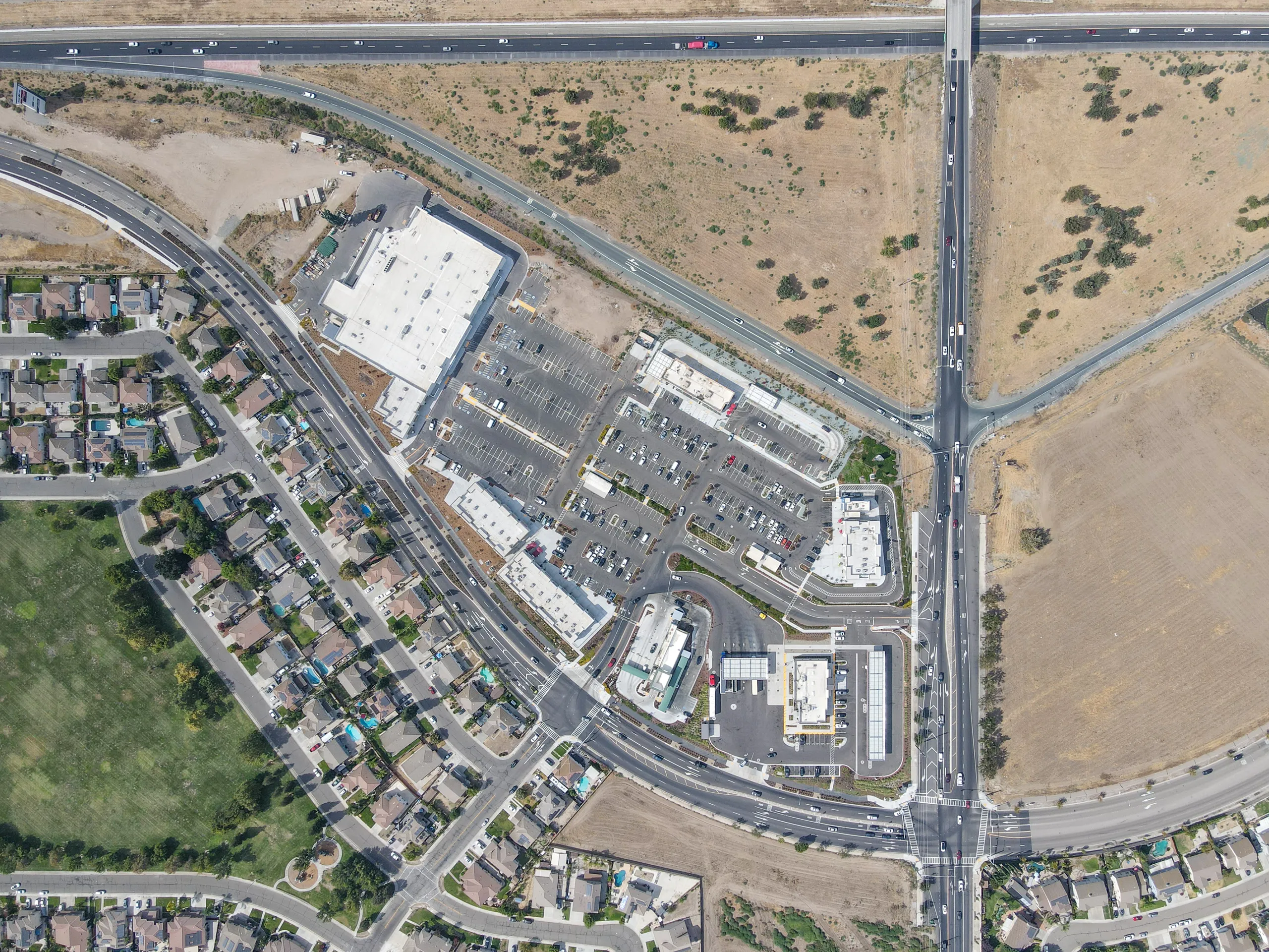 Top-down aerial view of the full Manteca Crossing site, with Highway 120 across the top and Airport Way on the right